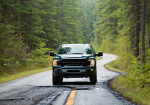 pickup-truck-driving-road-pothole-forest